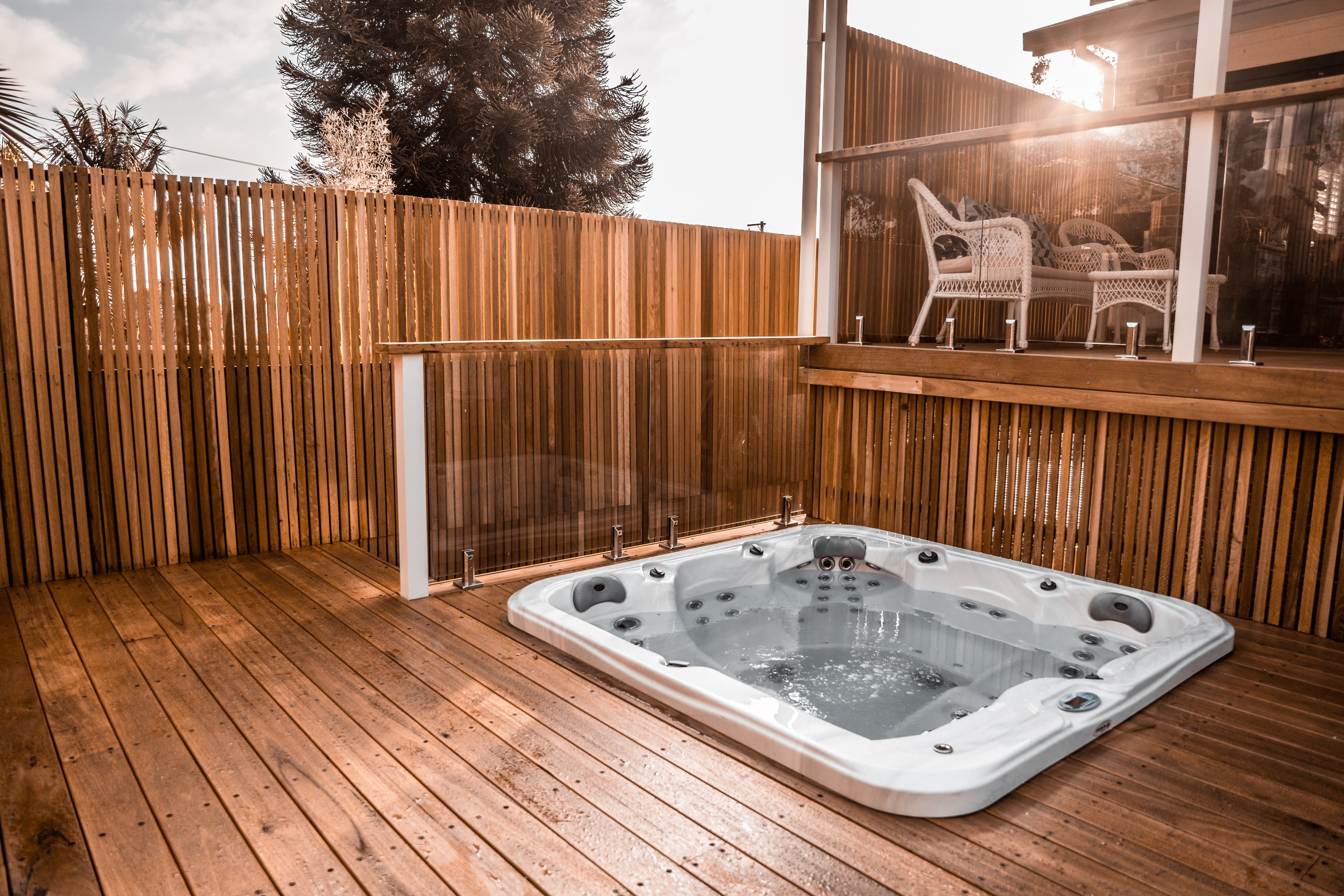 Engadine — spa on hardwood deck with cedar screening