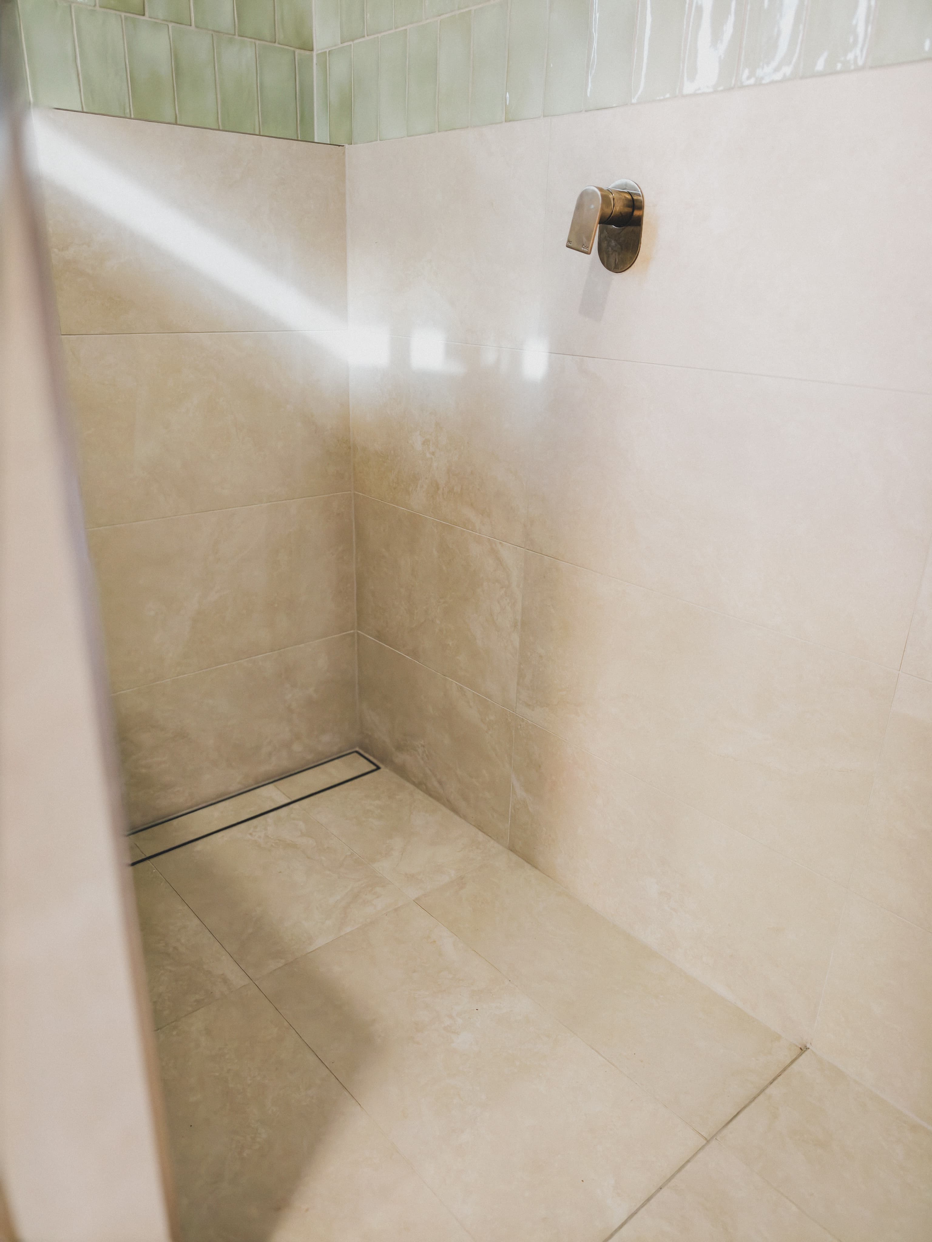 Fairy Meadow walk-in shower travertine tiles linear drain